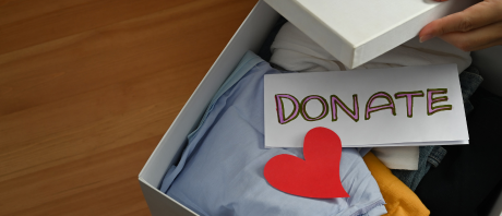 A box with items in it including a sheet of paper that reads "Donate"