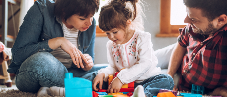 Parents play with their child.