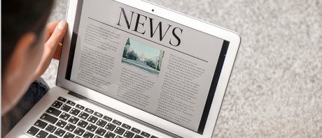 Person reading news on a laptop