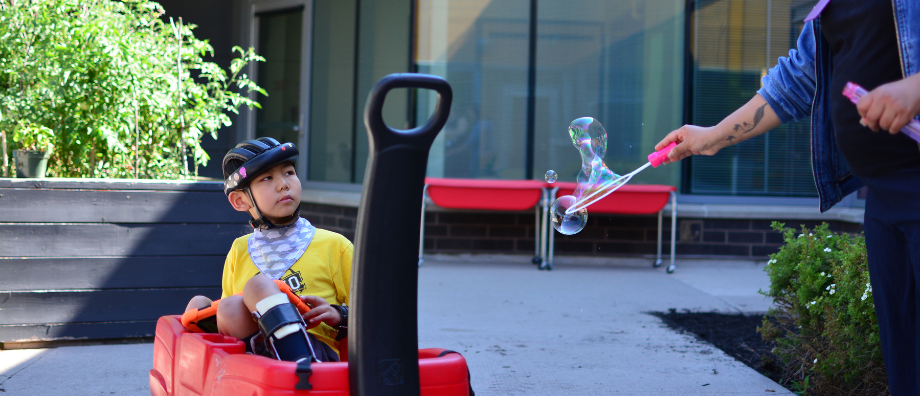 James in a wagon enjoying bubbles