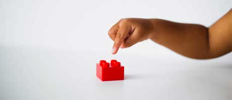 Child playing with Lego