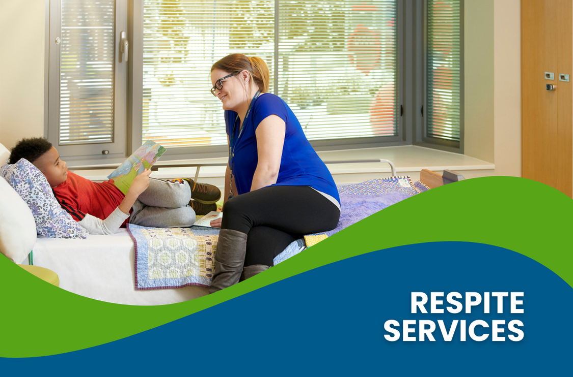 A respite worker speaking with a respite client who is in bed.