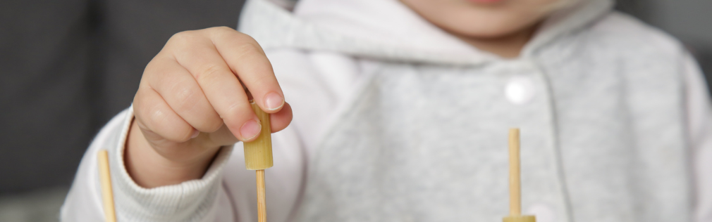 A young child does a fine motor activity 