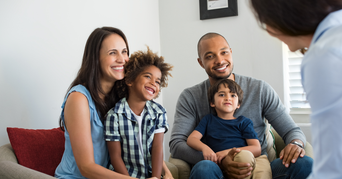 A family with two young children speak with a Resource Consultant