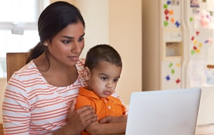 Mom and child looking at computer