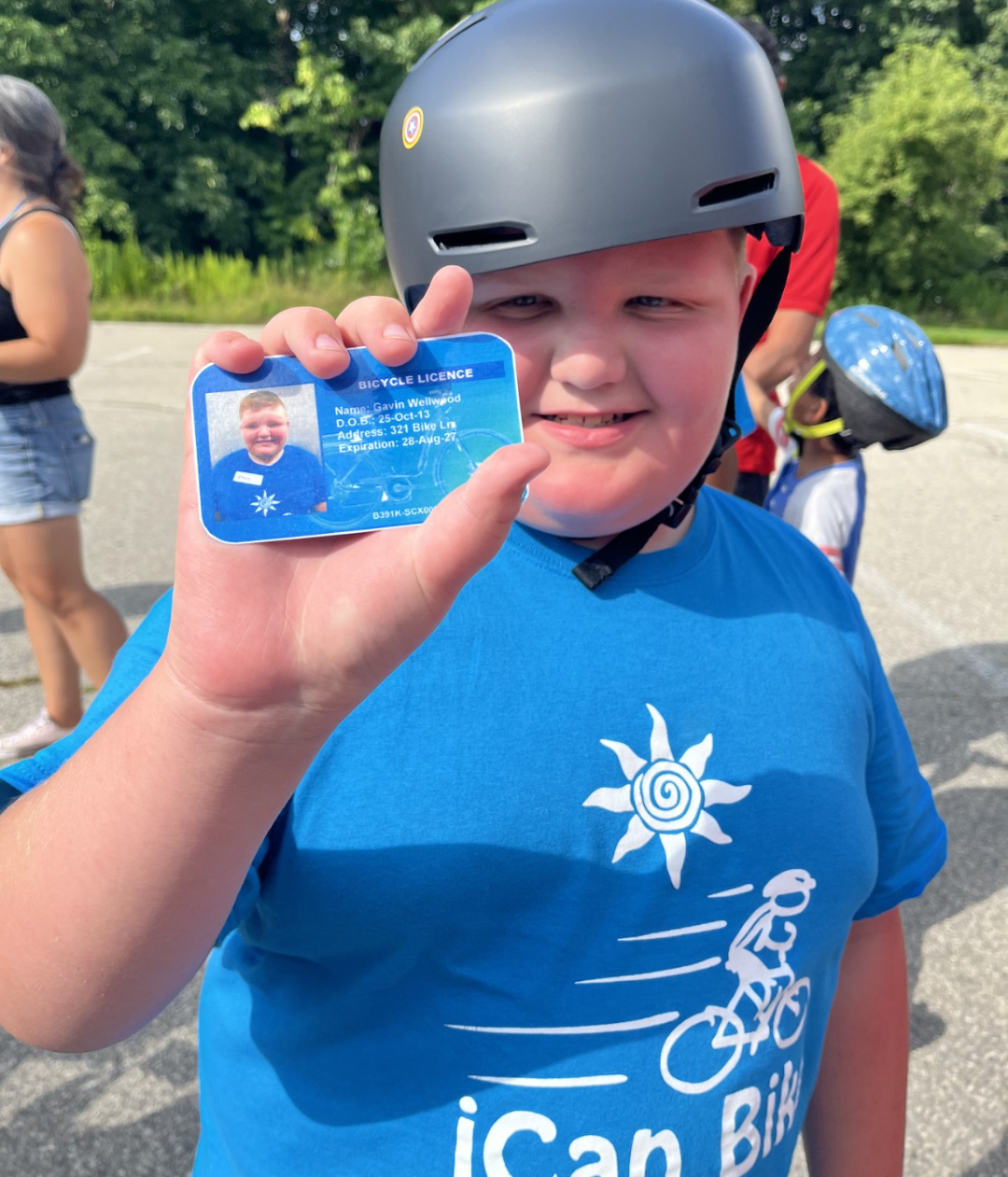 Gavin holds out his bicycle license