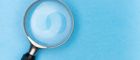 Magnifying glass on a blue background