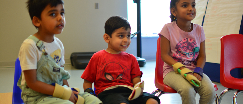 Three students with hemiplegia are hanging out at Helping Hands