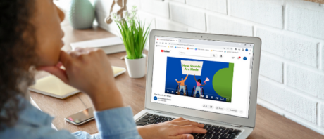 A woman on her laptop watching an ErinoakKids SLP video on YouTube