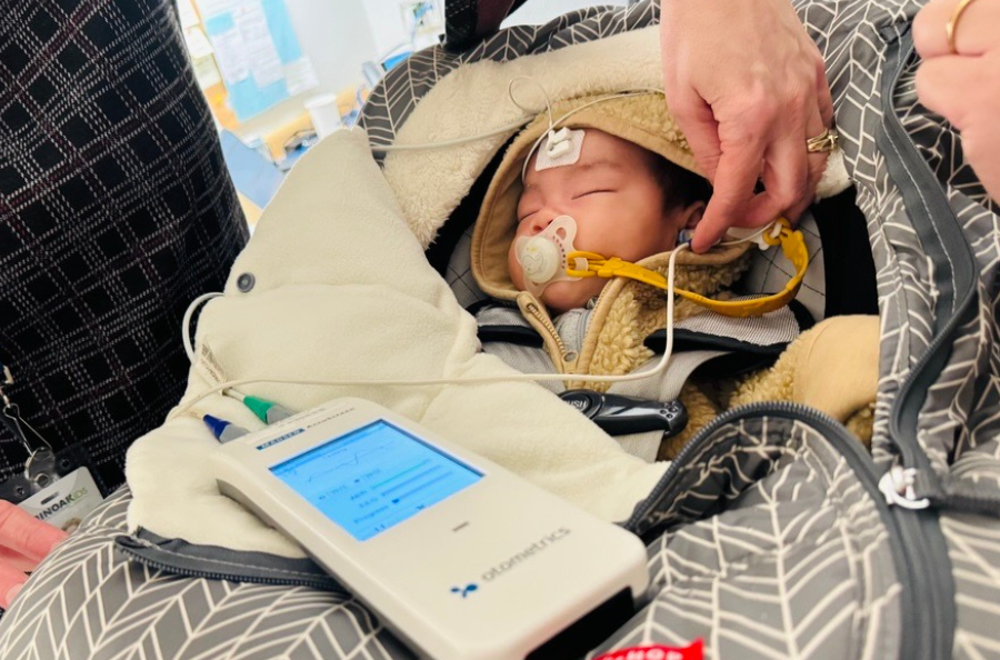 An infant getting a hearing screening using the Madsen® Accuscreen - Newborn Hearing Screener OAE/ABR