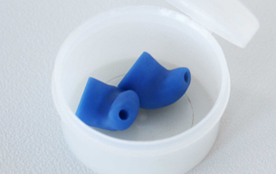 Blue ear plugs in a white container