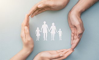 Hands circling a family