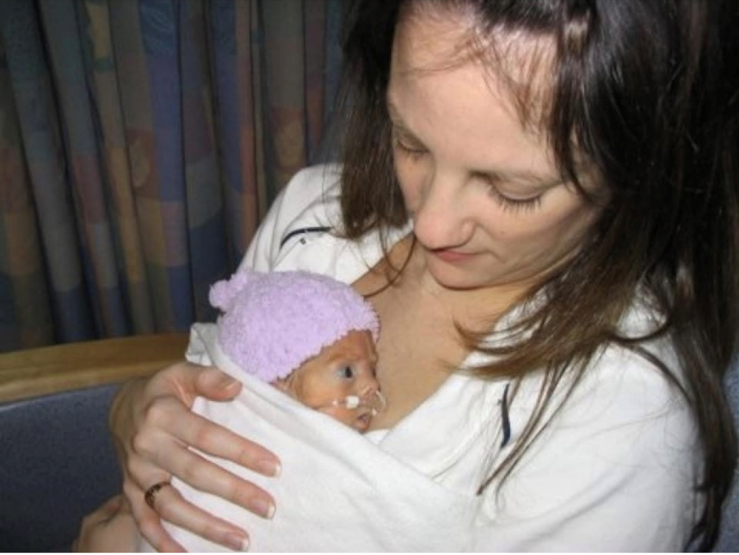 Angela holds Lizzy as a newborn against her chest