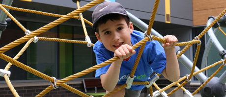 Boy playing on climbing equipment